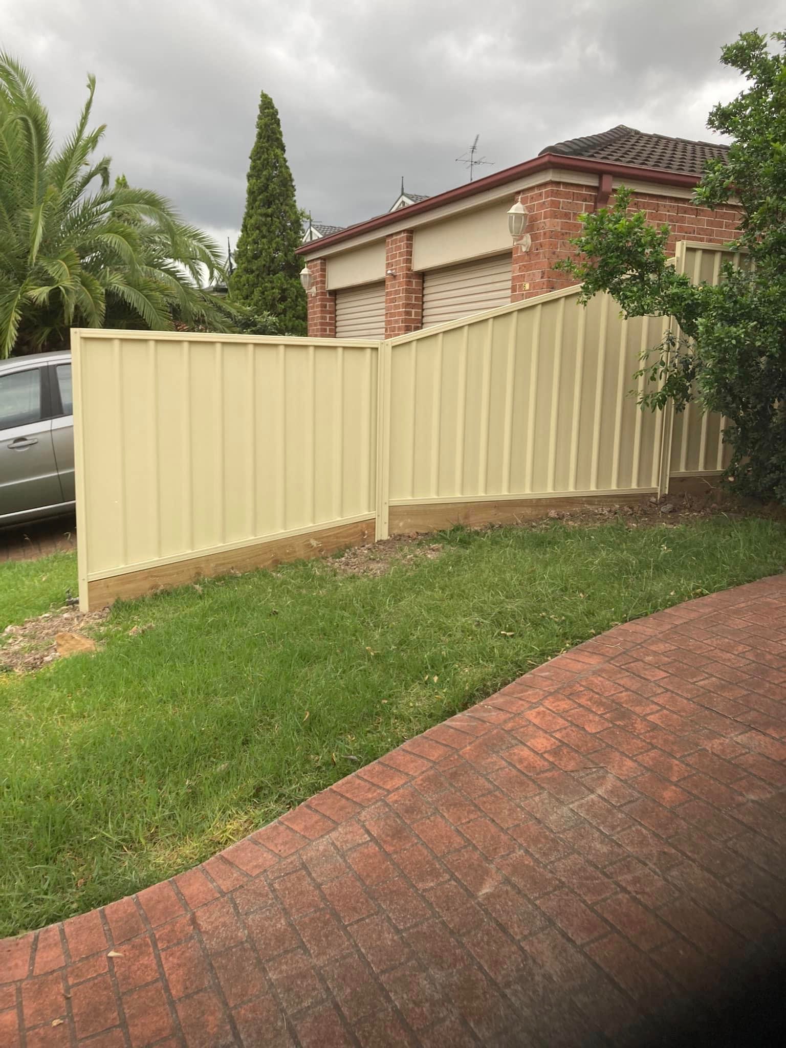 A cream Colorbond fence installed along a brick home in Western Sydney